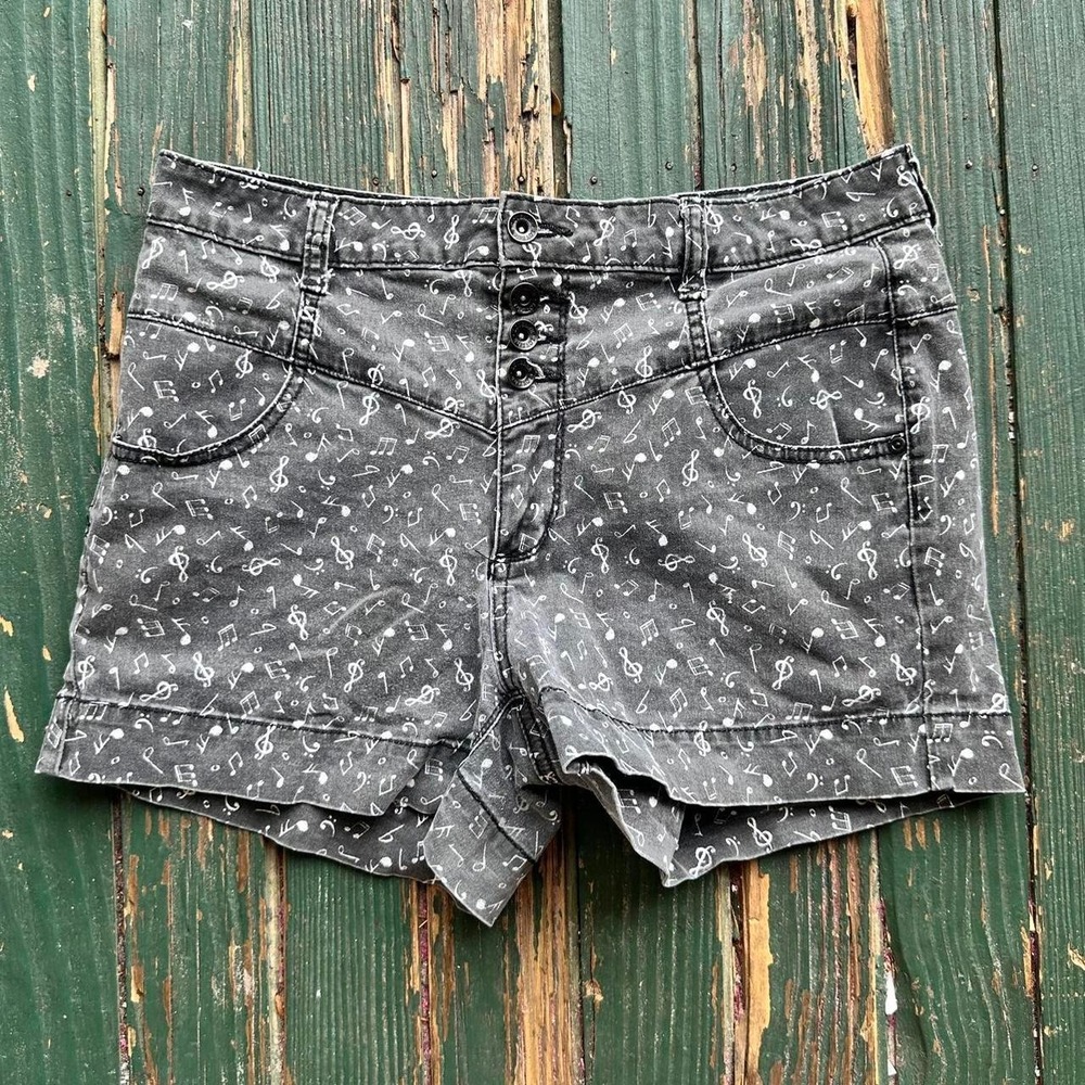 Grey and white patterned short shorts with a music theme